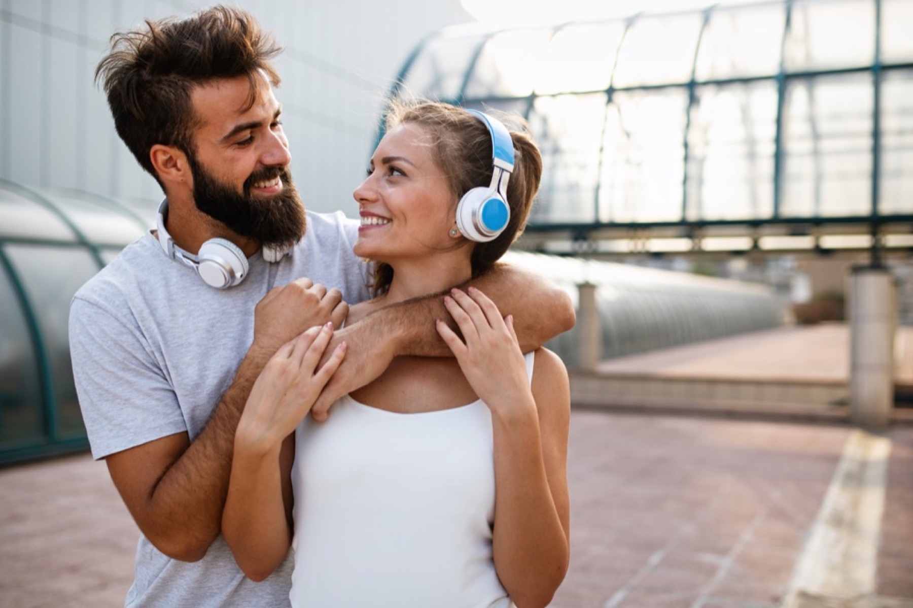A happy couple sharing earphones